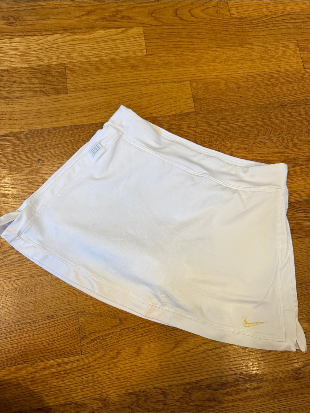 Nike White Women’s Tennis Skort with Gold Swoosh